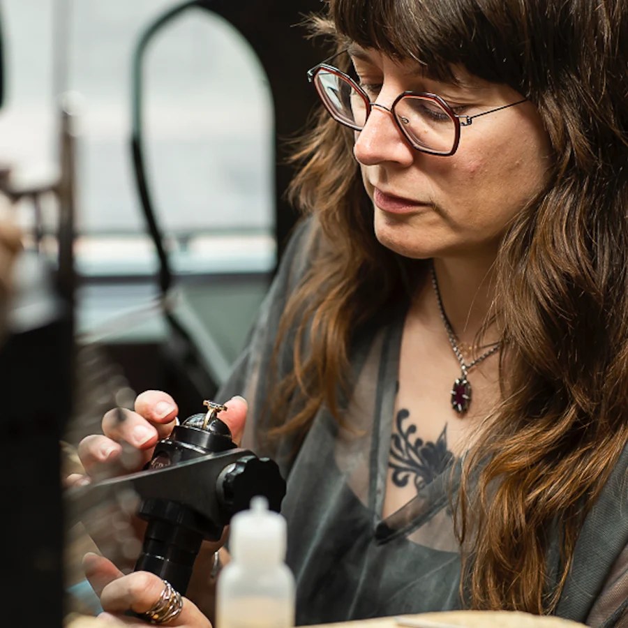 Jamie Hollier setting a stone in a ring at the bench