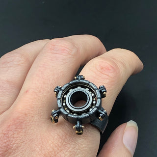 Sterling silver cocktail ring with hand crafted spinning parts accented with multi colored tourmalines and 22 karat yellow gold